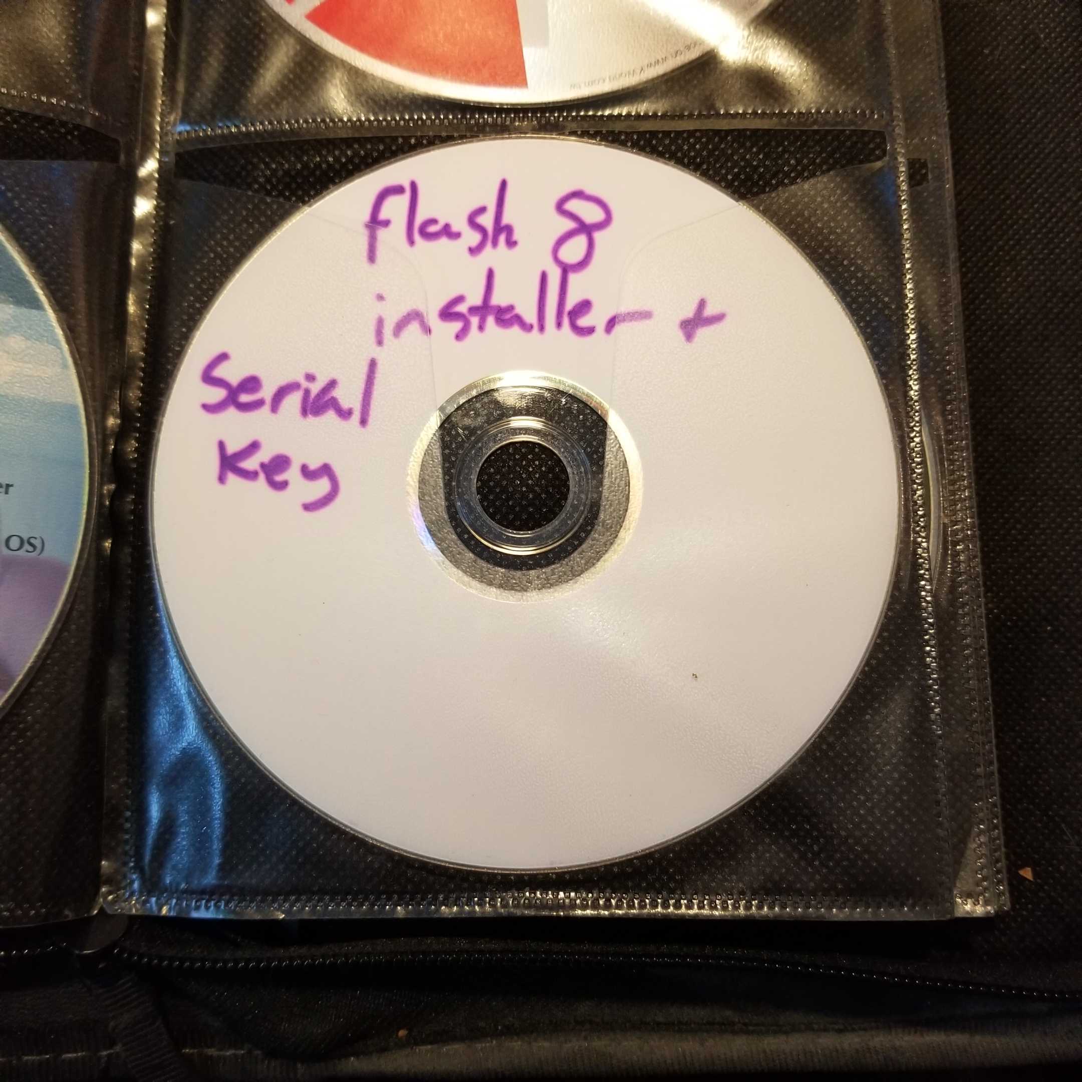 A CD with a handwritten label reading "Flash 8 installer + serial key"